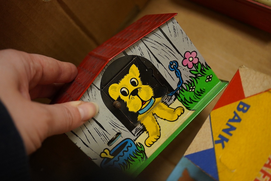 A group of thirteen novelty money boxes, including a Noddy book money box, a Snoopy money box and a Micky Mouse money box. Condition - varies